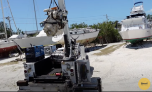 Diesel Pro Customer Imperial Diesel service, LLC, uses a crane to remove a Cummins 6BT from a Bertram